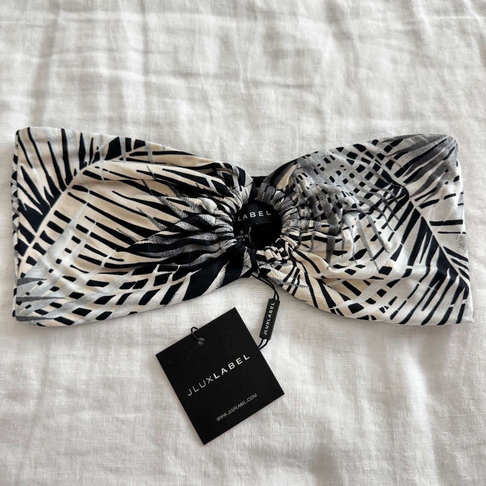 The Jlux label bandeau in size small is  new with tags attached.